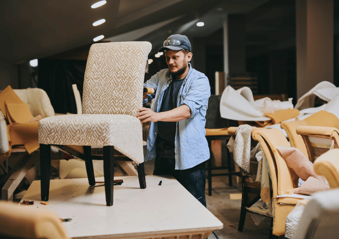 Custom furniture in Pakistan workshop showing craftsman inspecting handmade chair for made to order furniture