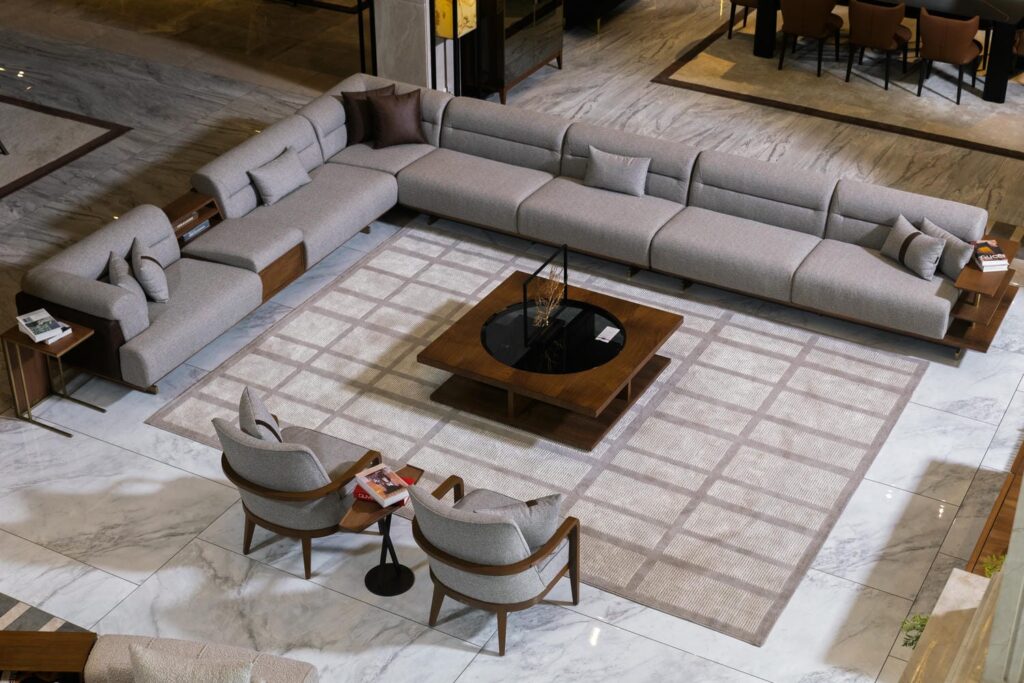 Modern Furniture in Pakistan featuring a luxury L-shaped sofa set with neutral colors in a contemporary living room interior