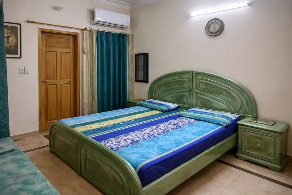 Traditional wooden bed furniture in a rural Pakistani bedroom interior