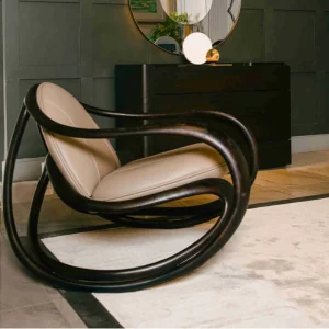 Stylish luxury chair with curved wooden frame and leather seat by NM Furnisher, representing luxury furniture in Pakistan