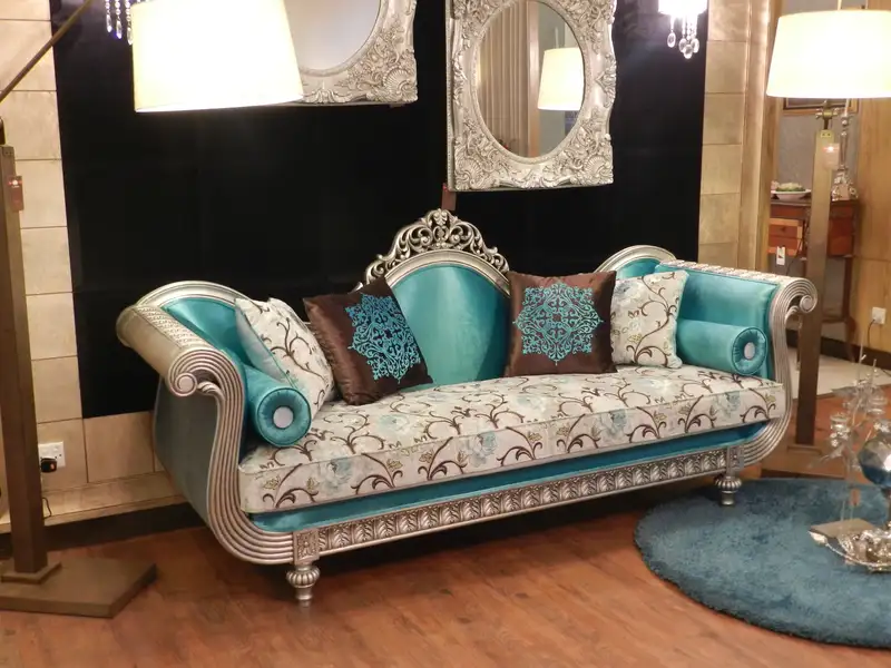 luxury classic sofa set design in Pakistan with carved wooden frame and teal fabric for elegant drawing room