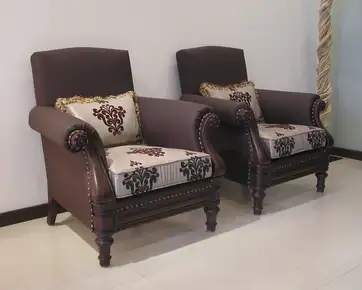 traditional wooden single seater sofa chair design in Pakistan with brown fabric and carved wooden legs