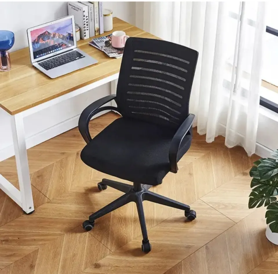 black computer office chair Pakistan placed near wooden desk in modern home workspace